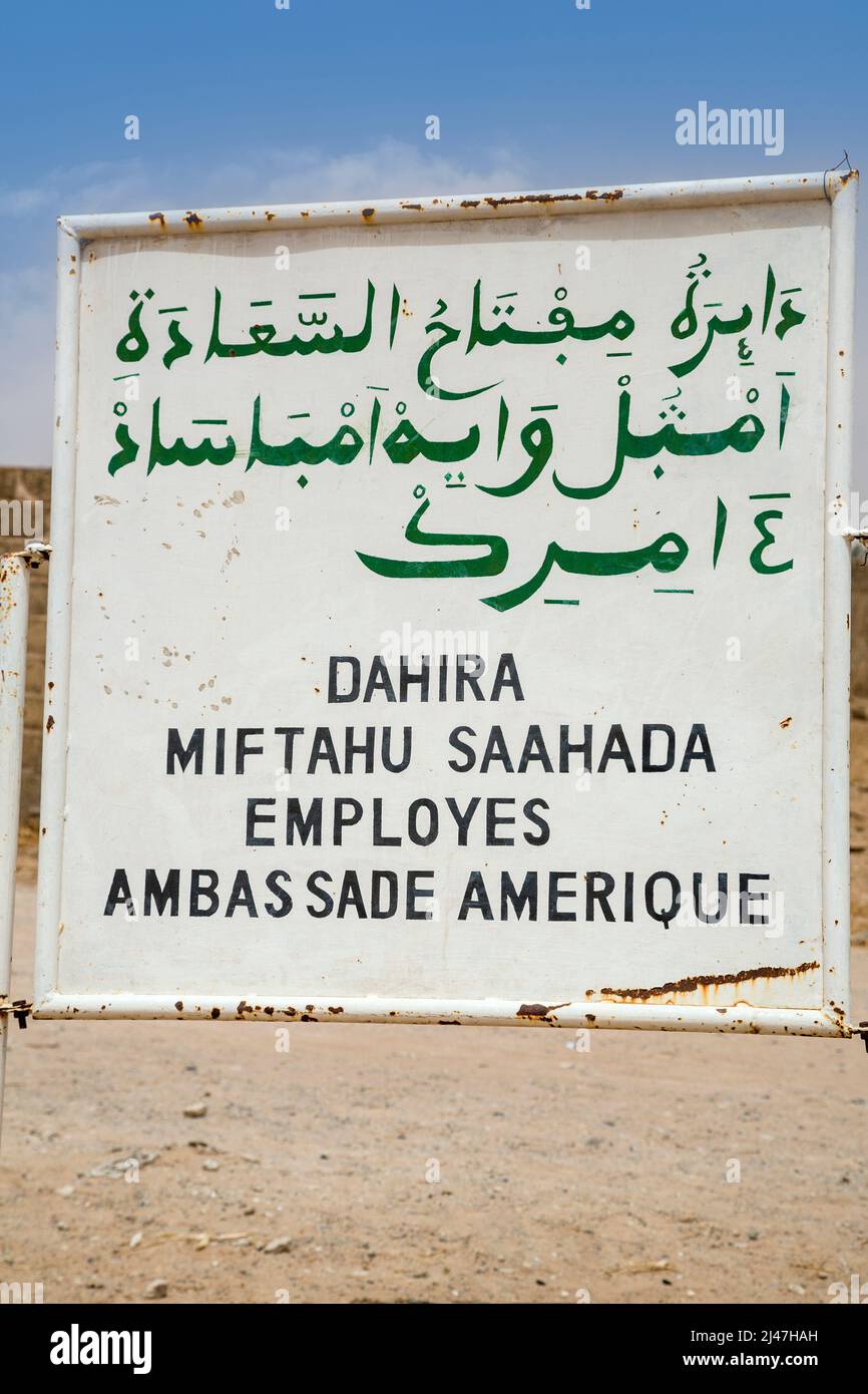 Senegal, Touba. Wolof, written in both Arabic and Latin script.  The sign indicates that a house is owned by the employees of the American embassy. Stock Photo