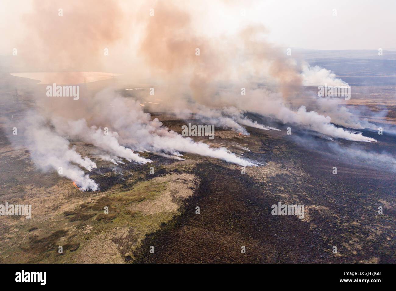Aerial view of smoke and flames from a large grassfire on moorland in South Wales, UK (Llangynidr Moors, Wales) Stock Photo