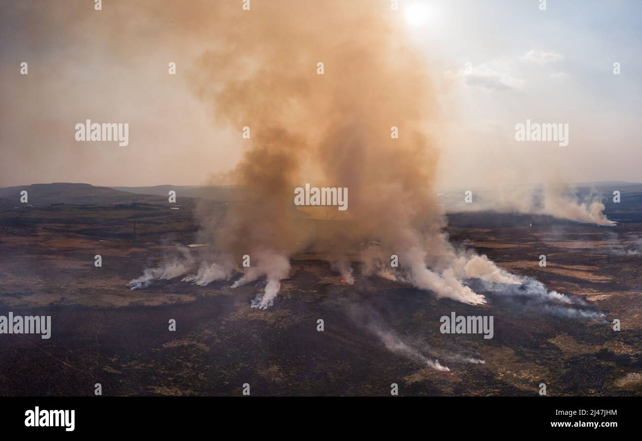 Aerial panoramic view of a large grassfire on moorland in Wales, UK Stock Photo
