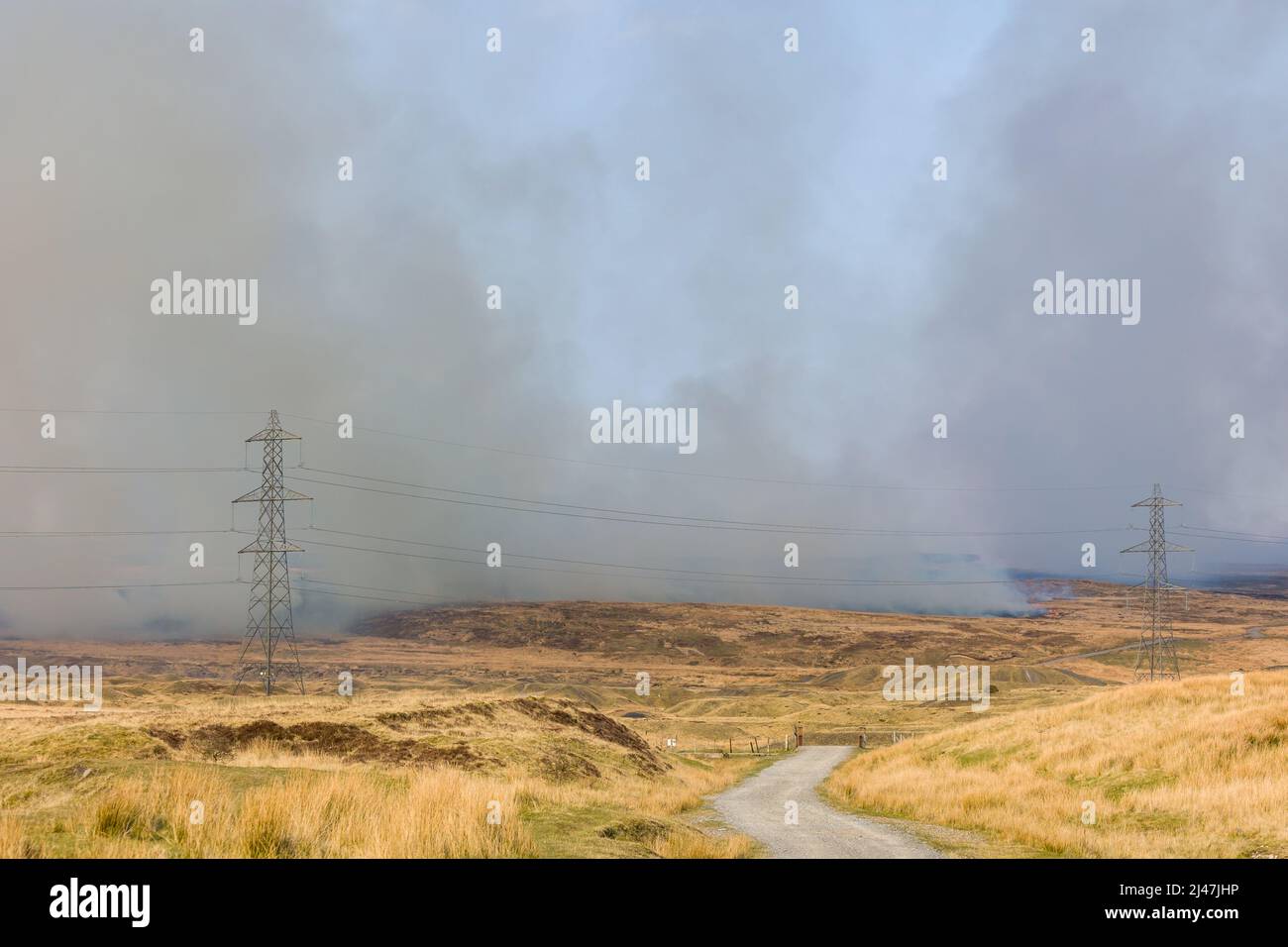 Fire fighters dealing with a large grassfire on an upland moors in Wales Stock Photo