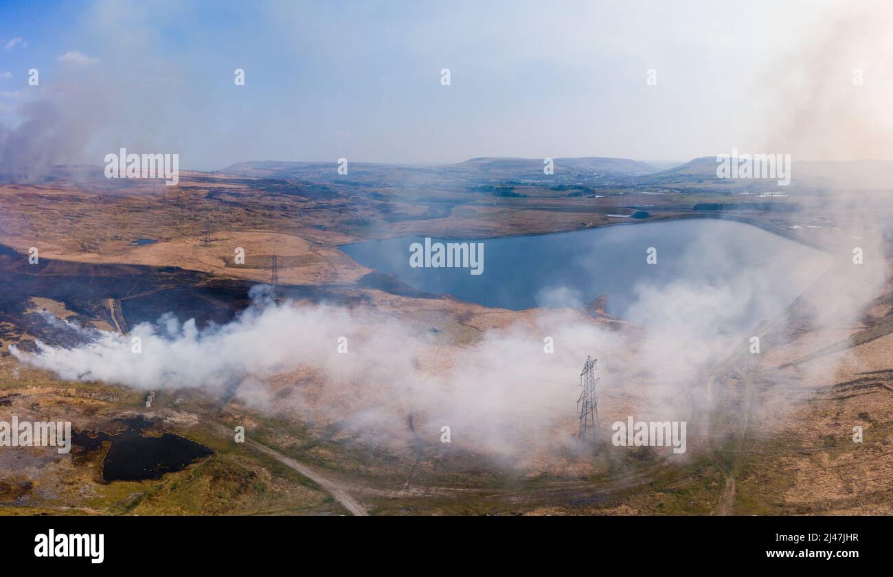 Aerial panoramic view of a large grassfire on moorland in Wales, UK Stock Photo