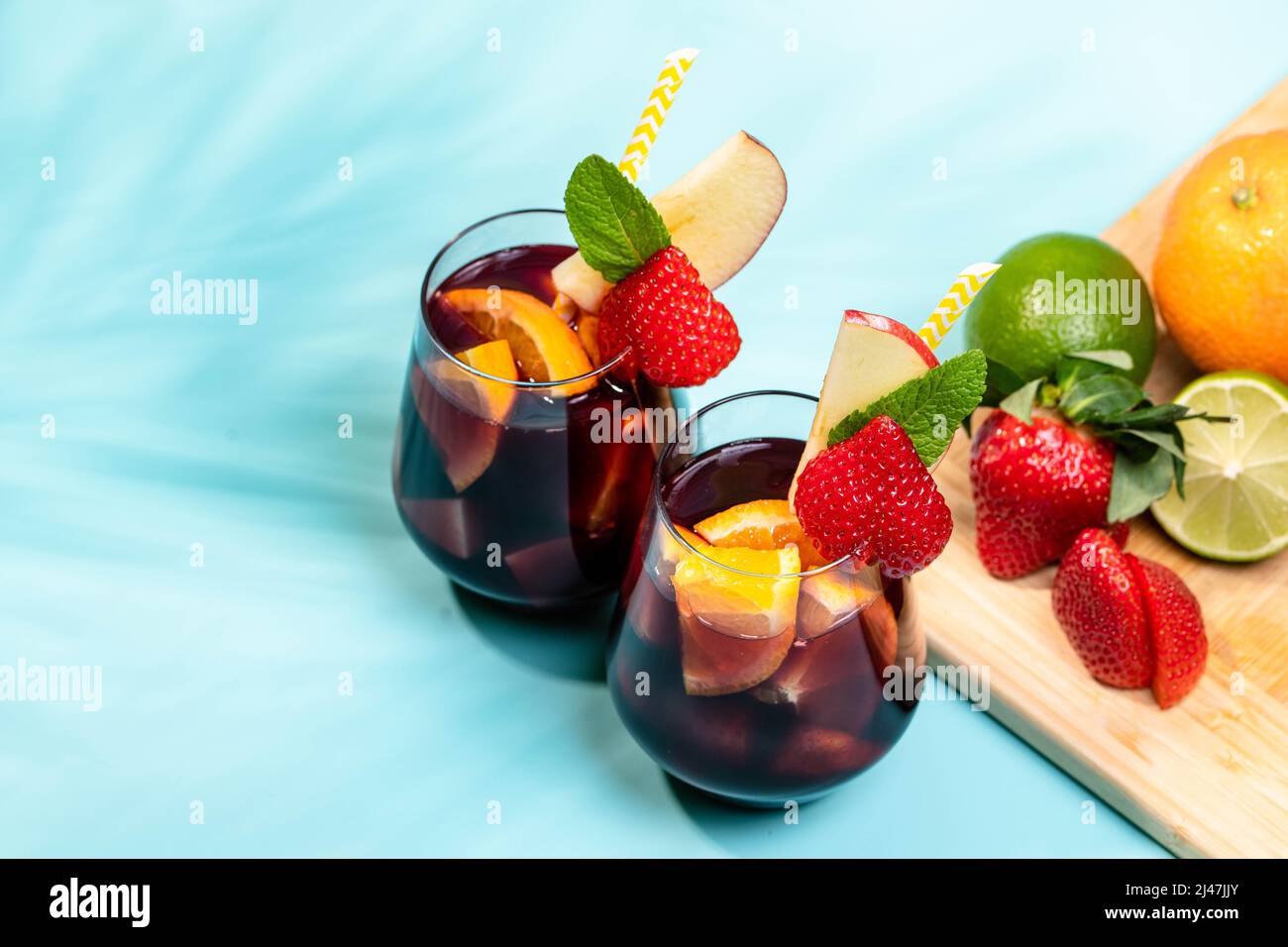 Preparation of traditional Spanish summer drink Sangria with fresh fruits, red wine and ice