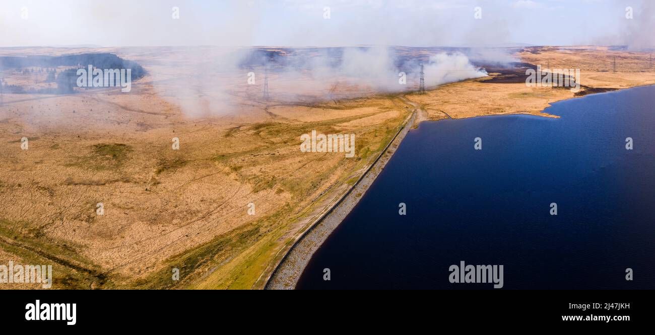 Aerial view of a huge wildfire on higher level moorland next to a reservoir (Llangynidr Moors, Wales) Stock Photo