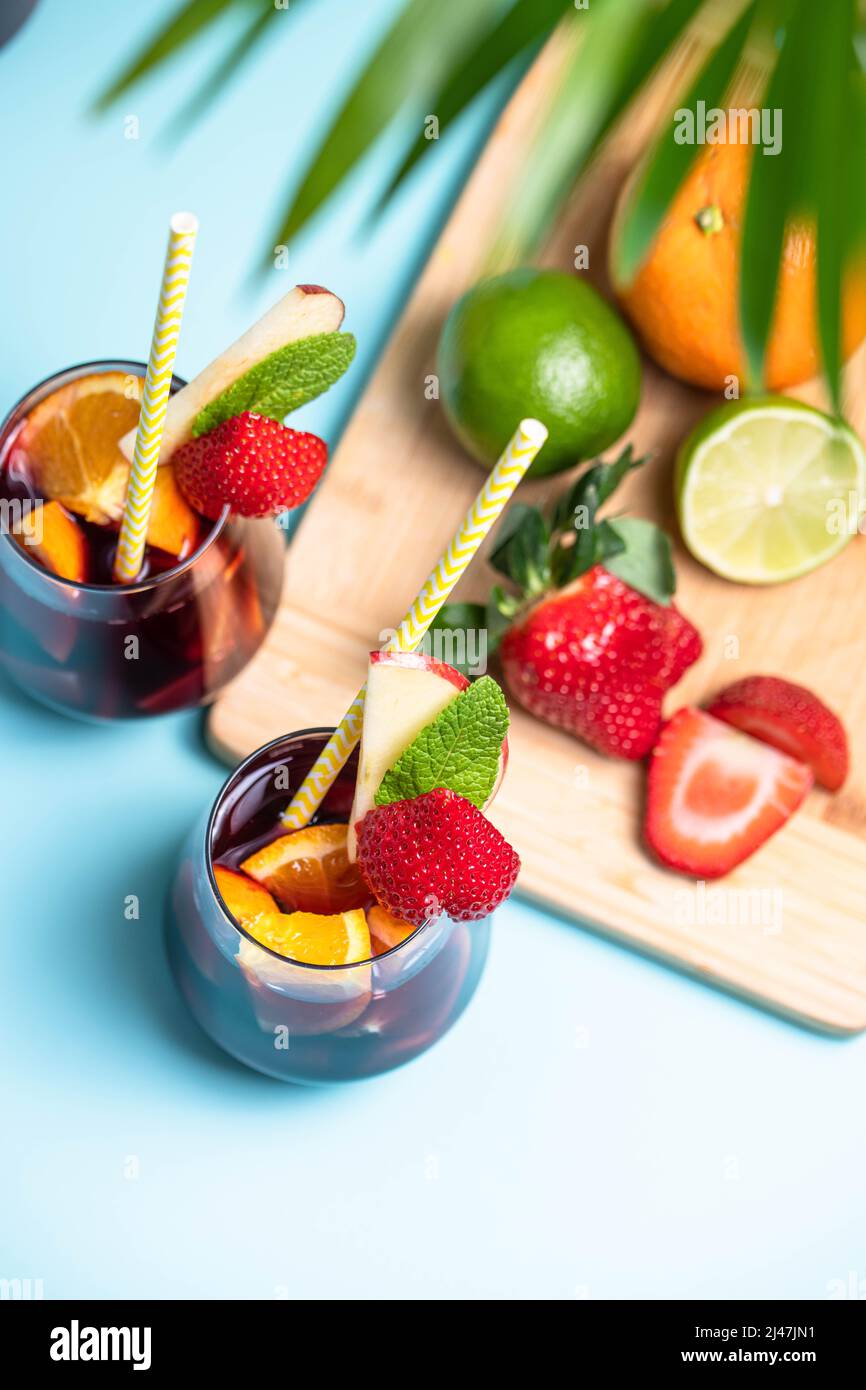 Preparation of traditional Spanish summer drink Sangria with fresh fruits, red wine and ice