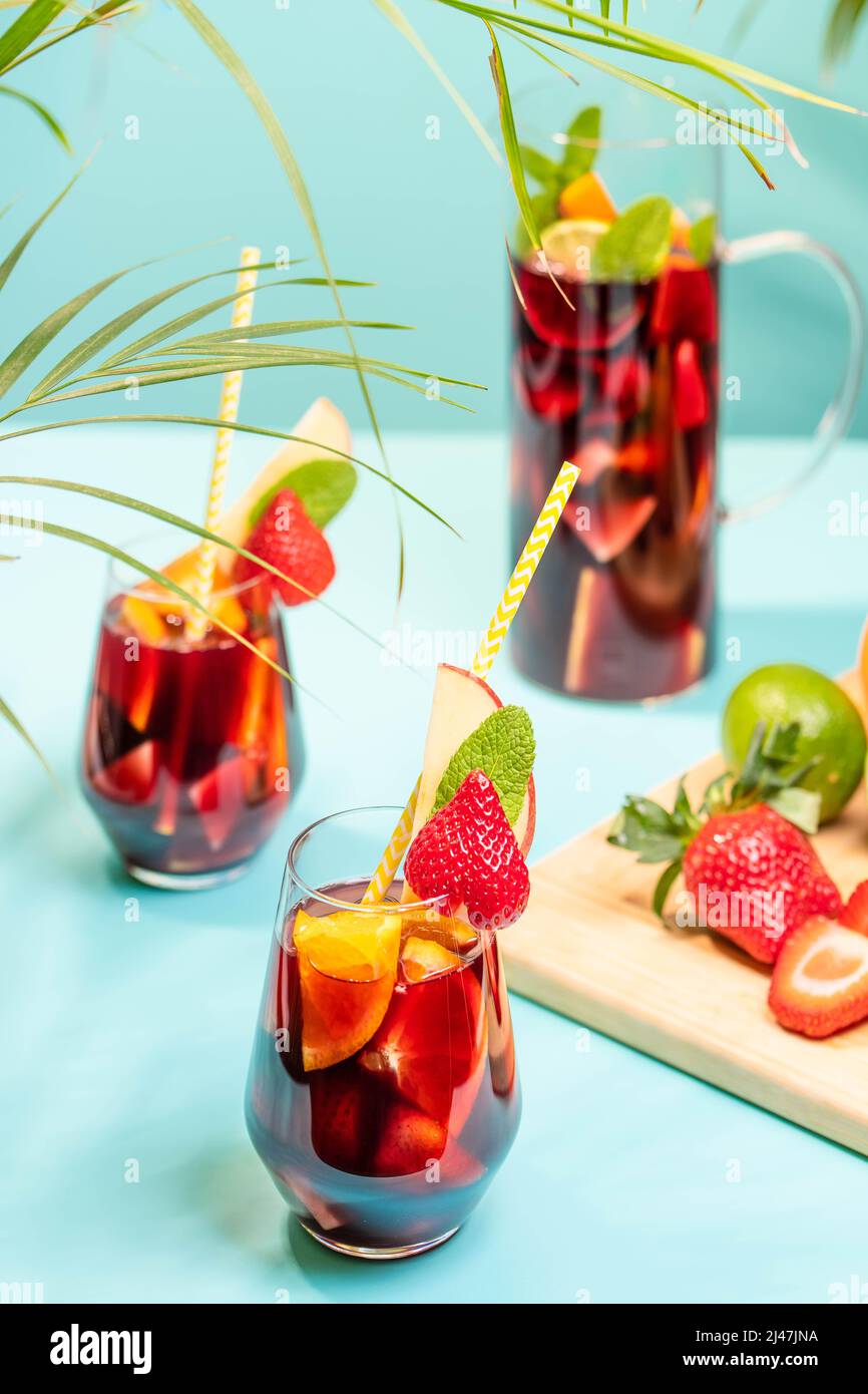 Preparation of traditional Spanish summer drink Sangria with fresh fruits, red wine and ice