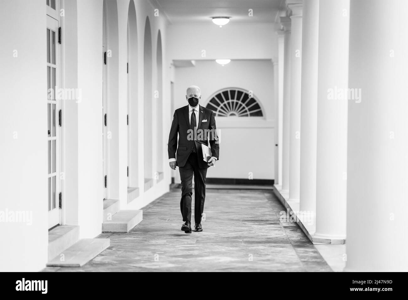 Washington, United States of America. 20 January, 2022. U.S President Joe Biden walks to the Oval Office throughout the West Colonnade of the White House January 20, 2022 in Washington, D.C.  Credit: Adam Schultz/White House Photo/Alamy Live News Stock Photo