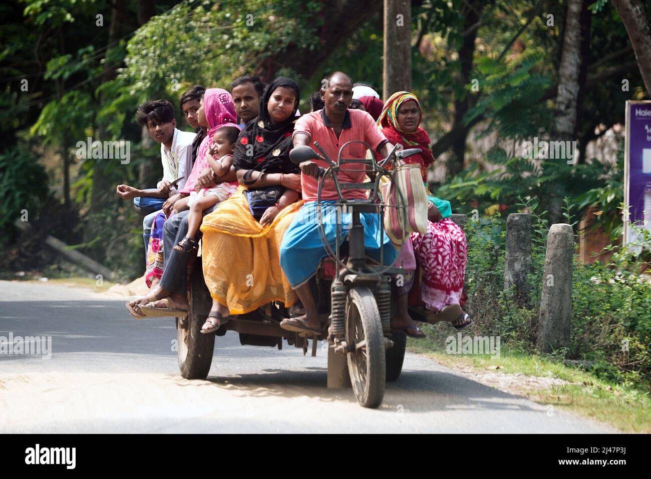 Passengers on a motor tricycle, street scene in Baruipur near Kolkata, India Stock Photo