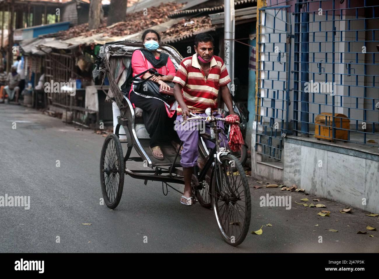 Passenger on a tricycle, street scene in Baruipur near Kolkata, India Stock Photo