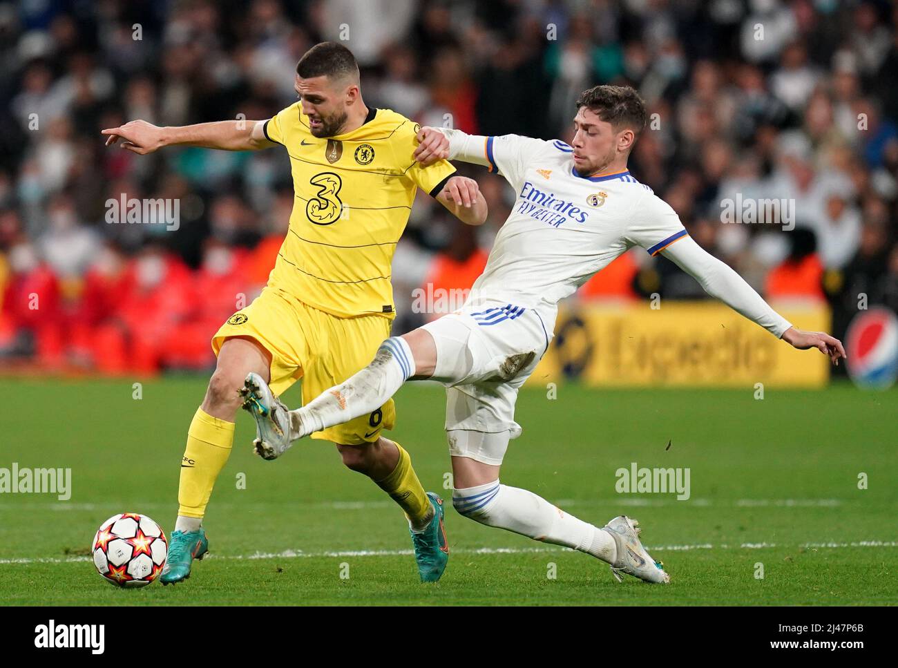 Chelsea's Mateo Kovacic (left) challenged by Real Madrid's Federico Valverde during the UEFA Champions League quarter final, second leg match at Santiago Bernabeu Stadium, Madrid. Picture date: Tuesday April 12, 2022. Stock Photo