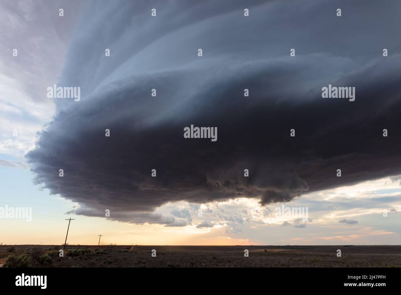 Dark storm clouds rolling over a field near Amherst, Texas Stock Photo