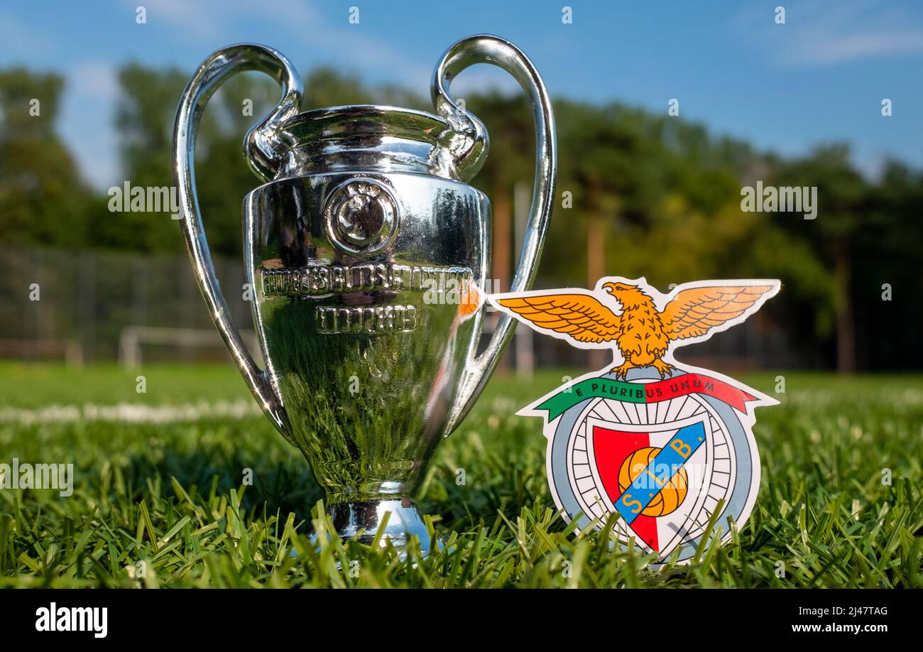 August 30, 2021, Lisbon, Portugal. S.L. football club emblem Benfica and the UEFA Champions League Cup on the green turf of the stadium. Stock Photo