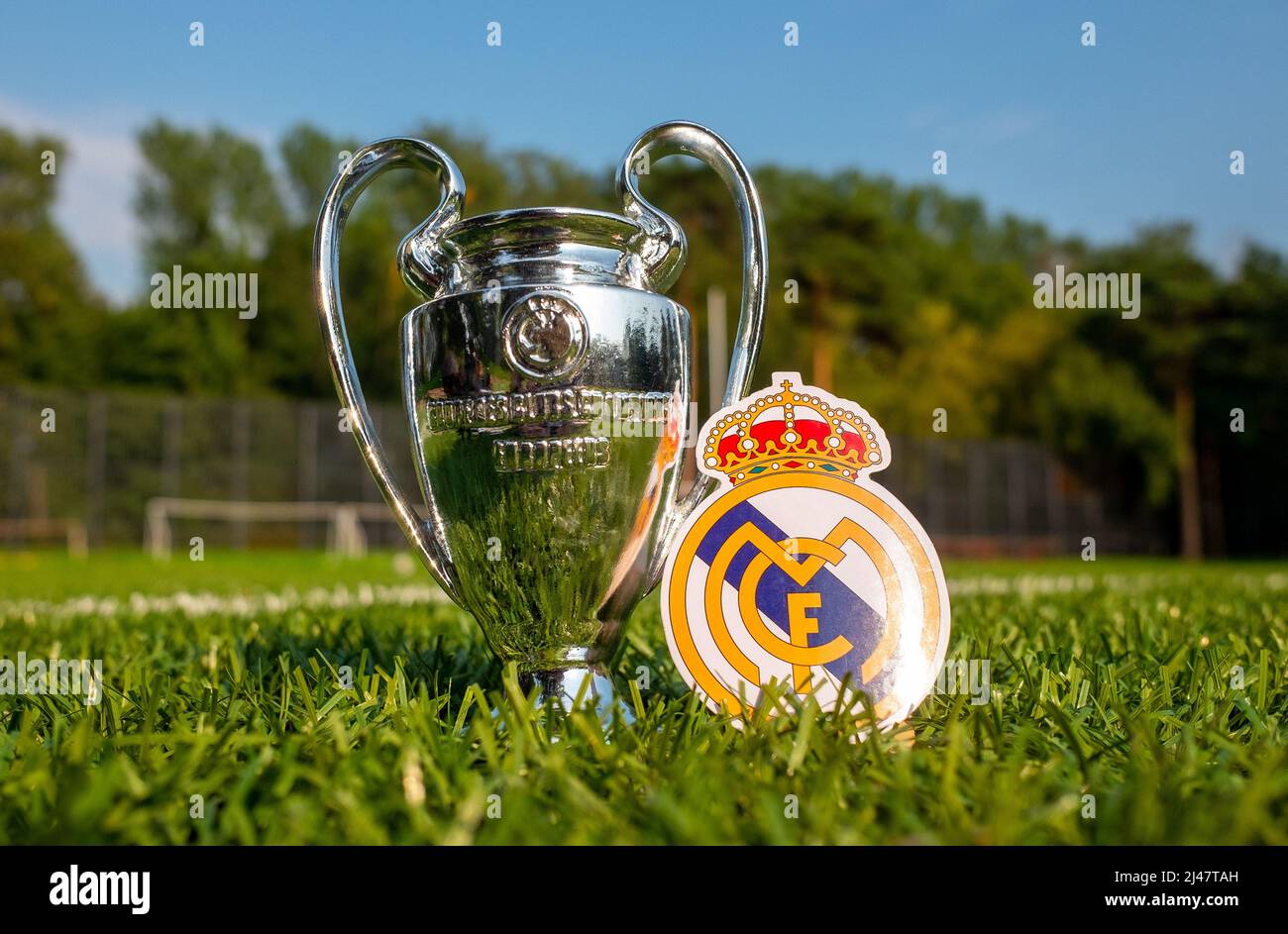 August 30, 2021, Madrid, Spain. The emblem of the football Real Madrid CF and the UEFA Champions League Cup on the green turf of the stadium. Stock Photo