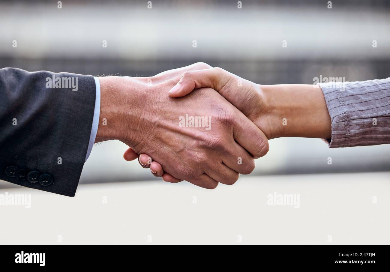 Its a done deal. Shot of a group of unrecognizable businesspeople shaking hands. Stock Photo