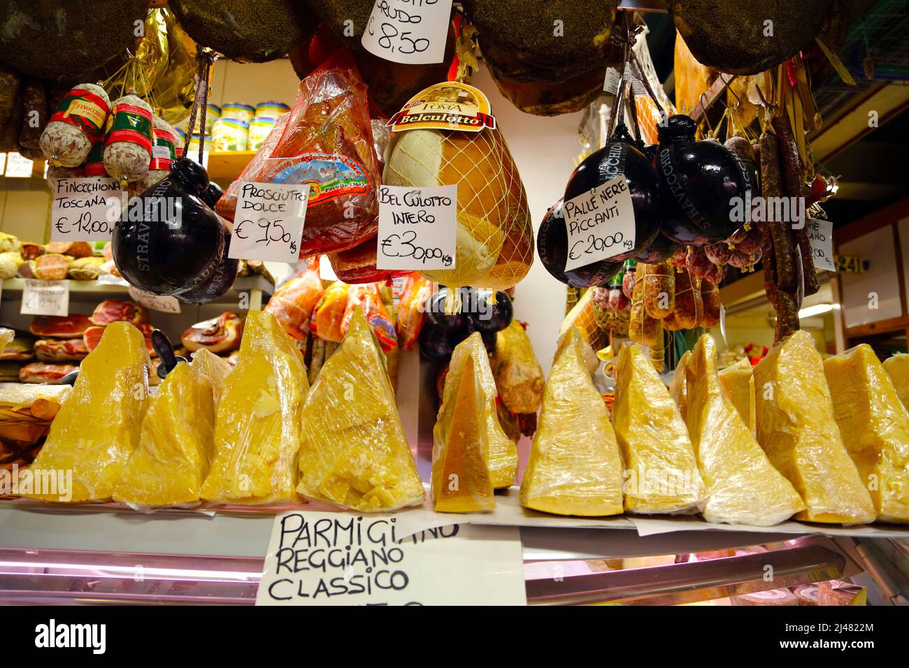 A selection of hams, salami and cheese on display in San Lorenzo market in Florence Italy Stock Photo