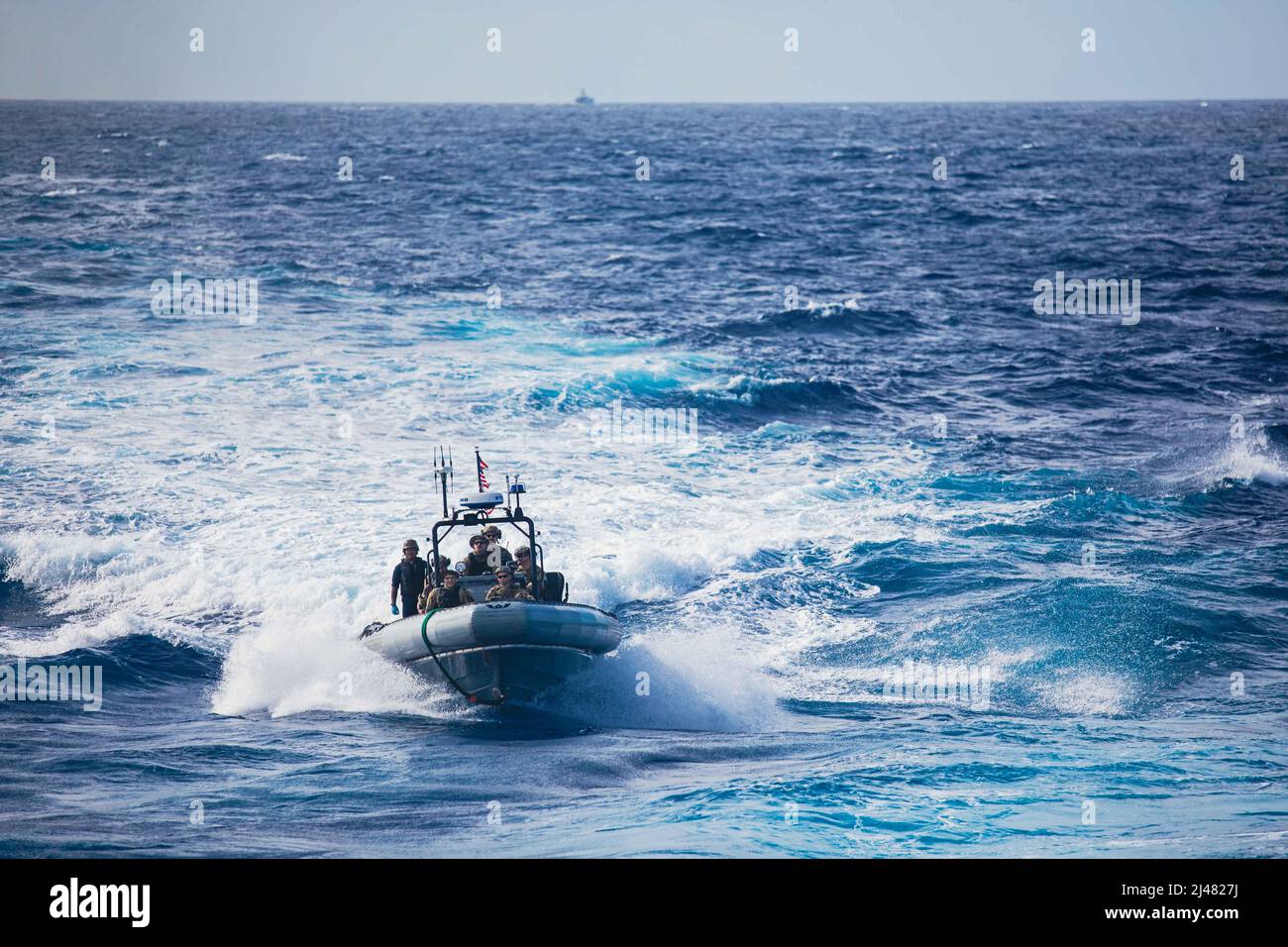 220406-N-GF955-1019  CARIBBEAN SEA - (April 6, 2022) -- Coast Guardsmen assigned to the “Los Ochos Locos” of Law Enforcement Detachment (LEDET) 408 and Sailors assigned to the Freedom-variant littoral combat ship USS Billings (LCS 15) recover the rigid-hull inflatable boat (RHIB) after conducting counter narcotics operations with the Coast Guard cutter Joseph Tezanos (WPC 1118), April 6, 2022. Billings is deployed to the U.S. 4th Fleet area of operations to support Joint Interagency Task Force South’s mission, which includes counter-illicit drug trafficking missions in the Caribbean and Easter Stock Photo