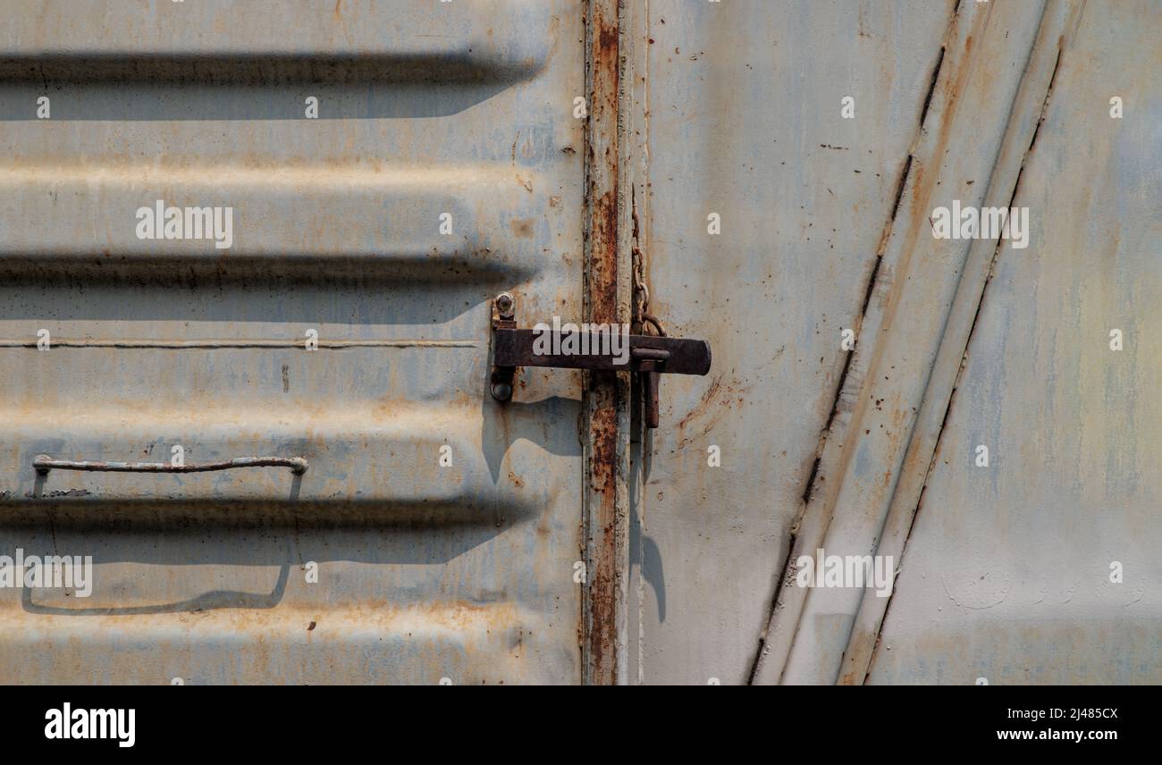Metal lock at Vintage railroad container doors gates in old station