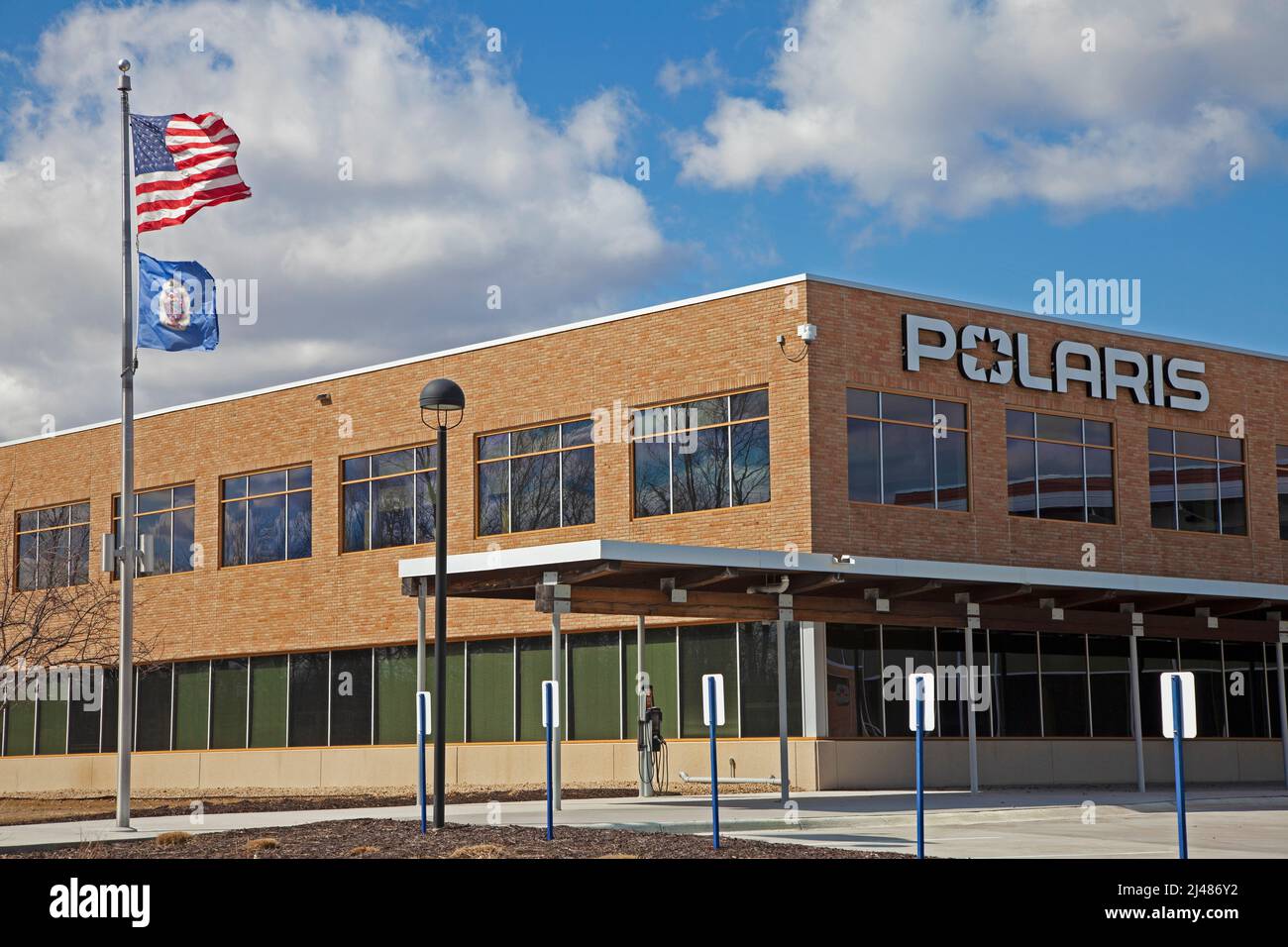 Polaris Inc Global Headquarters manufacturing plant for snowmobiles and all terrain vehicles flying American & Minnesota flags. Medina Minnesota MN USA Stock Photo
