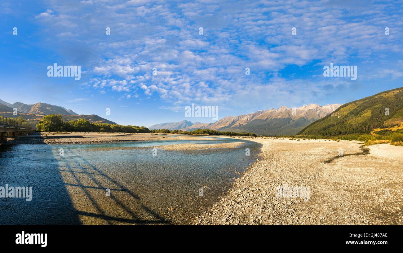 The beautiful clear blue aqua water in the Rees river close to Glenorchy heading for Lake Sylvan Stock Photo