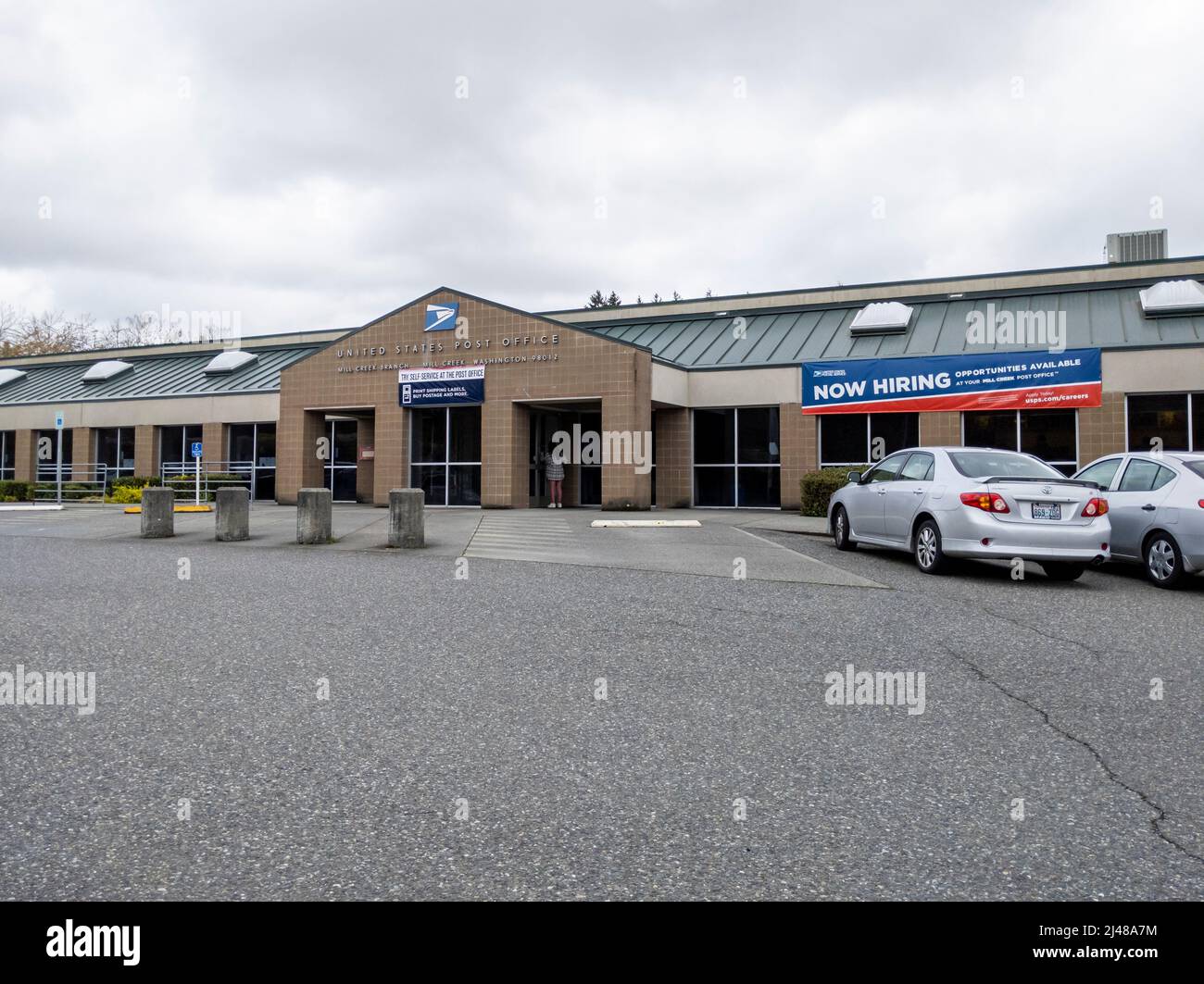 Lynnwood, WA USA - circa April 2022: View of a Now Hiring sign outside of the Mill Creek United States Postal Service building Stock Photo