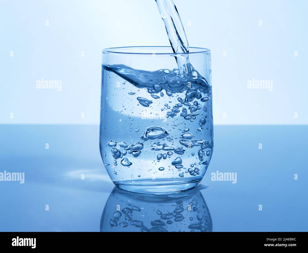 A glass of water can do the world of good. Studio shot of a glass of water being poured in