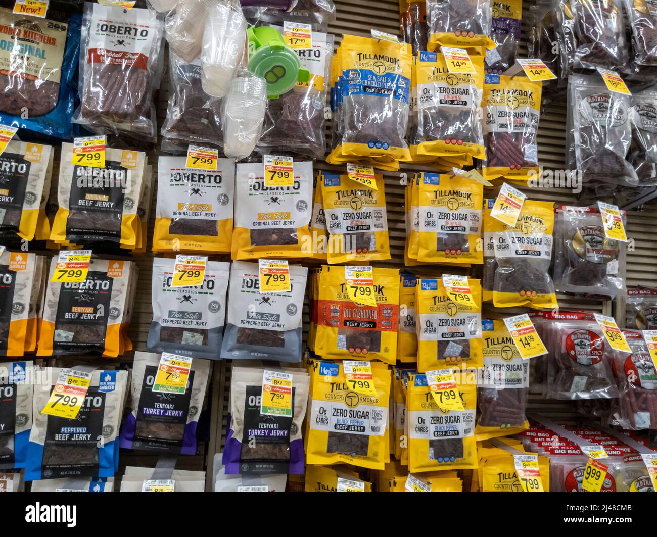 Woodinville, WA USA - circa April 2022: Angled view of a large variety of beef jerky and sausage links for sale inside a Haggen grocery store. Stock Photo