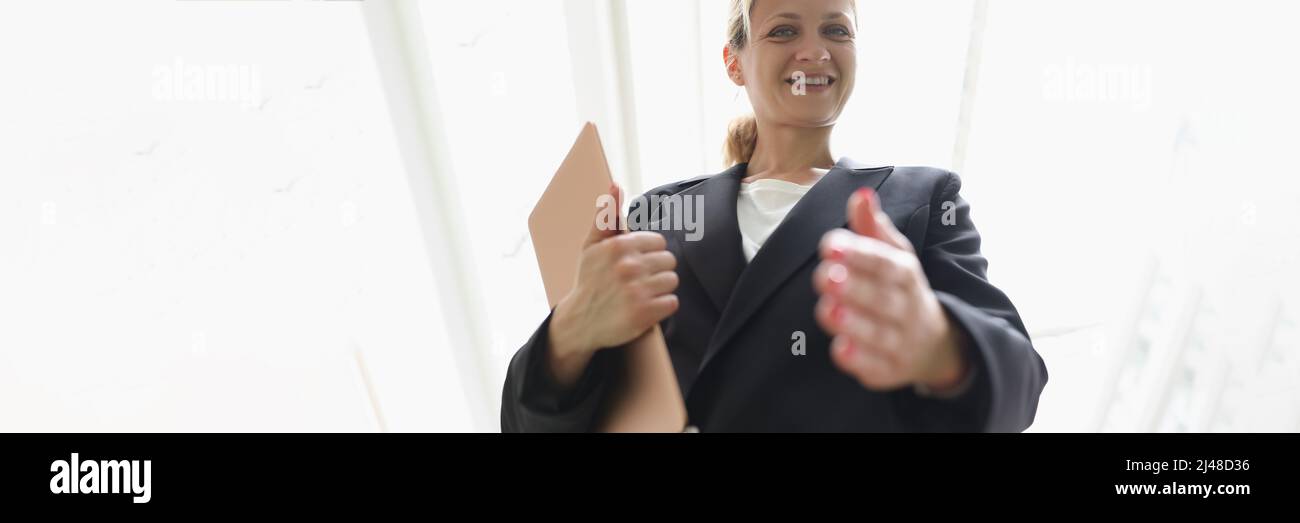 Young woman in business suit stretching out her hand for handshake bottom view Stock Photo