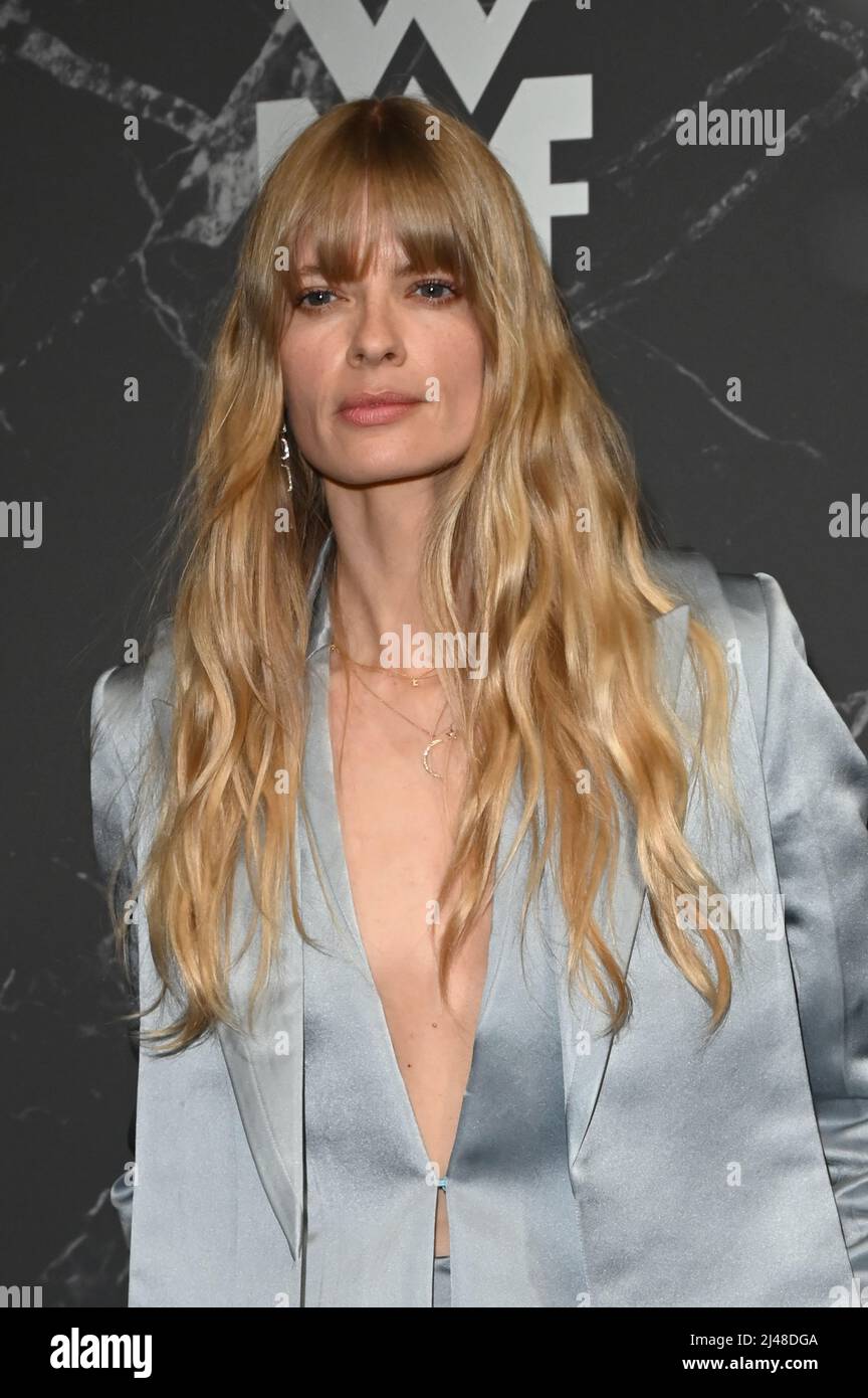 Munich, Germany. 12th Apr, 2022. Model Julia Stegner smiles at the WMF world premiere of a fully automatic coffee machine at the Haus der Kunst in Munich. Credit: Düren/dpa/Alamy Live News Stock Photo