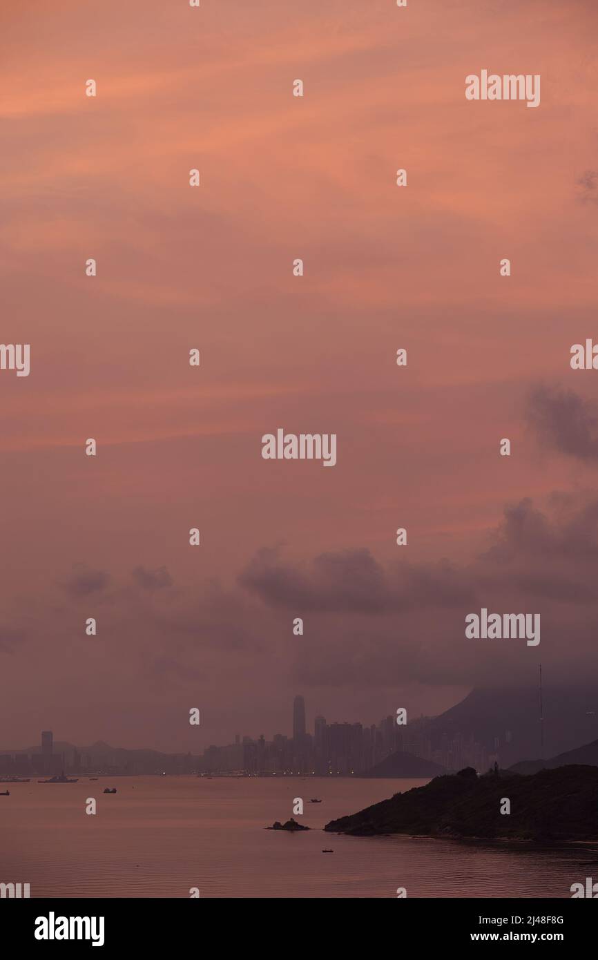 The city skyline at dawn (pink) seen from a highrise apartment block