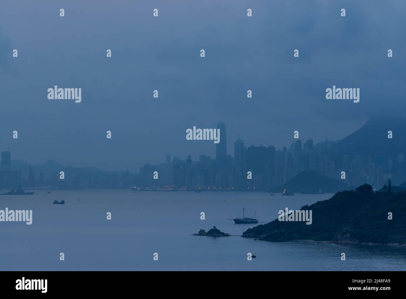 The city skyline at dawn (blue) seen from a high-rise apartment block in Discovery Bay, Lantau Island, Hong Kong, 2007 Stock Photo
