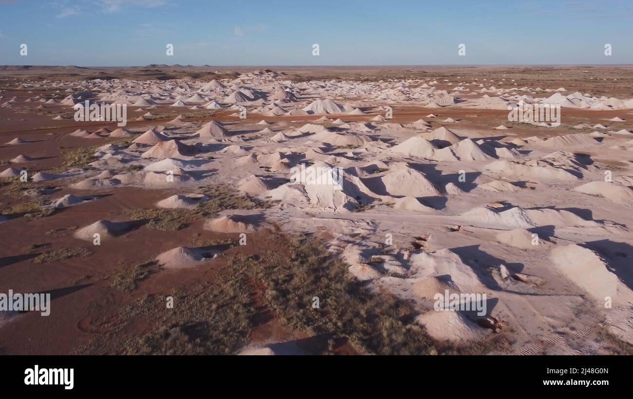 an aerial shot flying over opal mine tailings at coober pedy on a winter afternoon in outback south australia Stock Photo