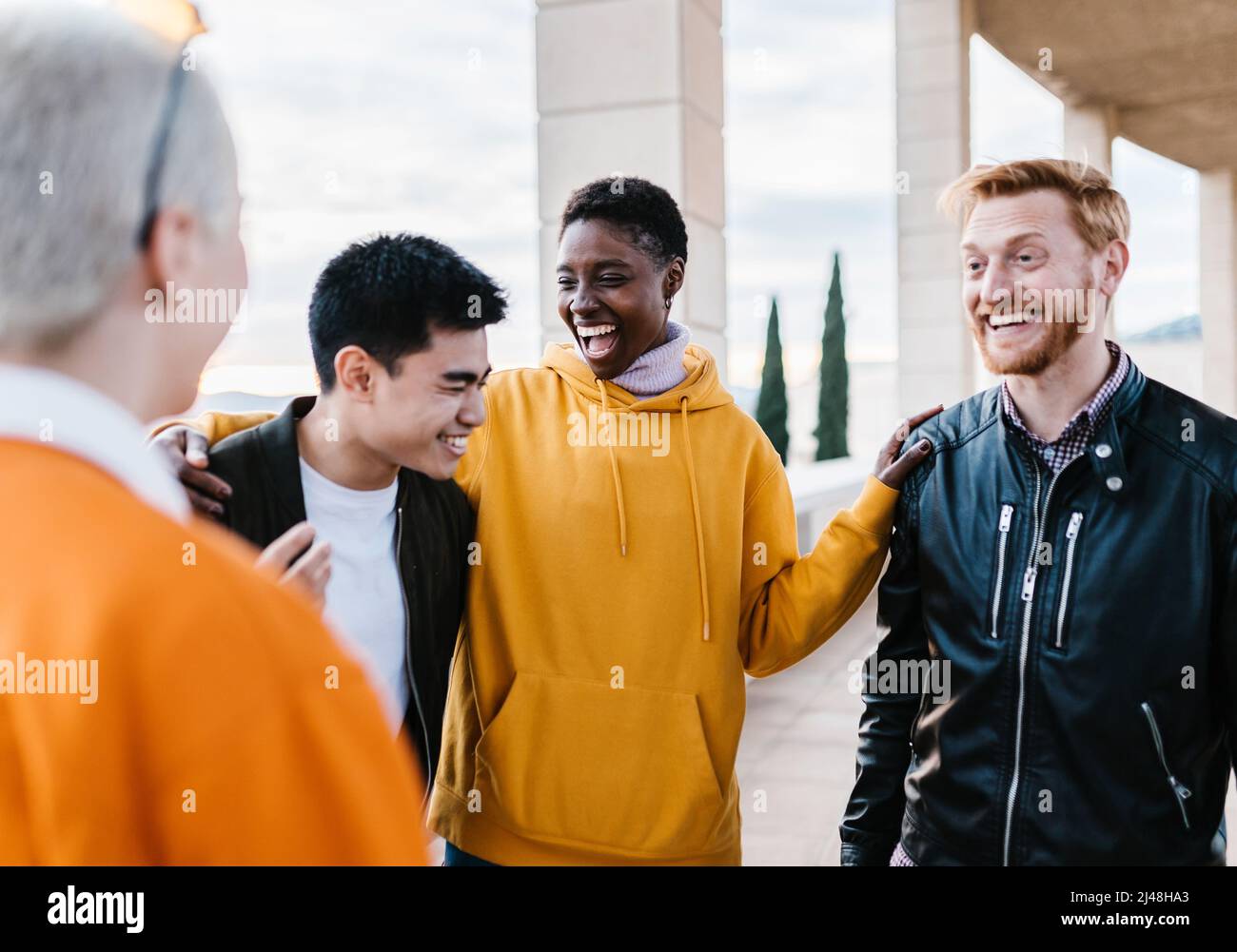 Group of young multiracial friends enjoying time together outdoors. Stock Photo