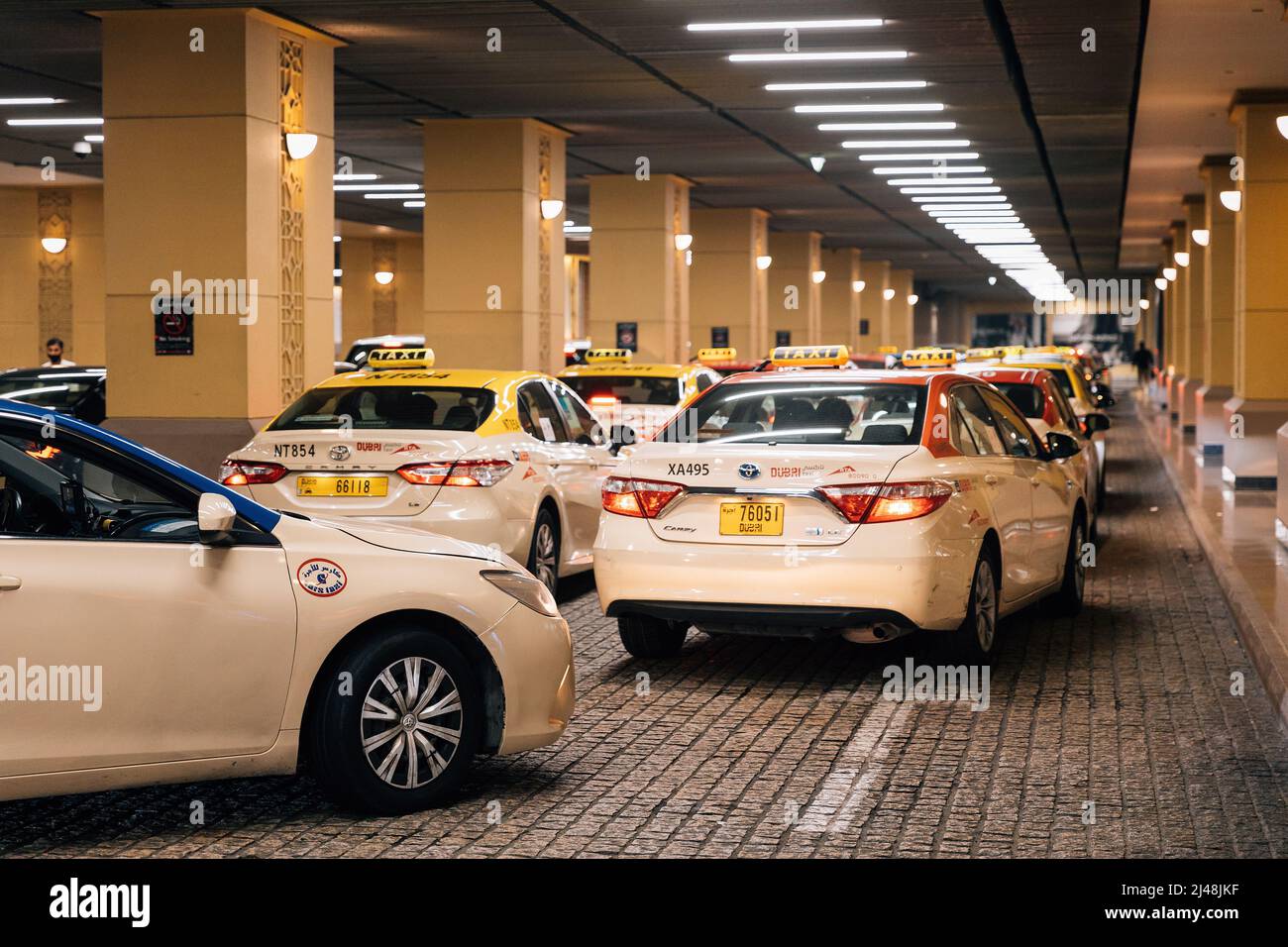Dubai, UAE, United Arab Emirates - May 22, 2021: Taxi cars parking at the Dubai mall. Taxi parking at the shopping center, shopping mall. Traffic on Stock Photo