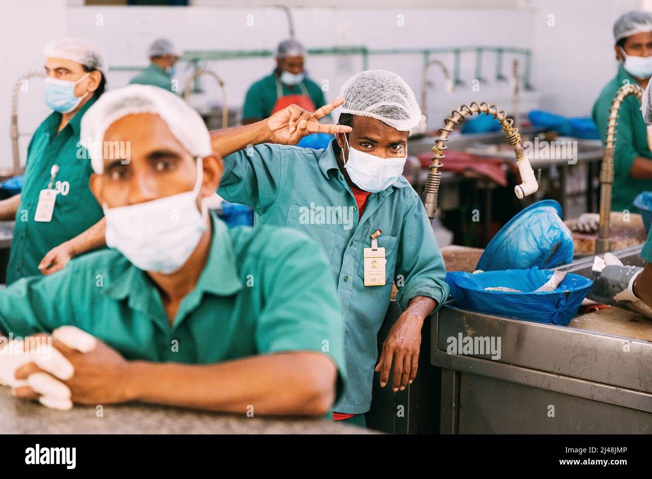 Ajman, UAE, United Arab Emirates May 26, 2021 Men cleaning fresh