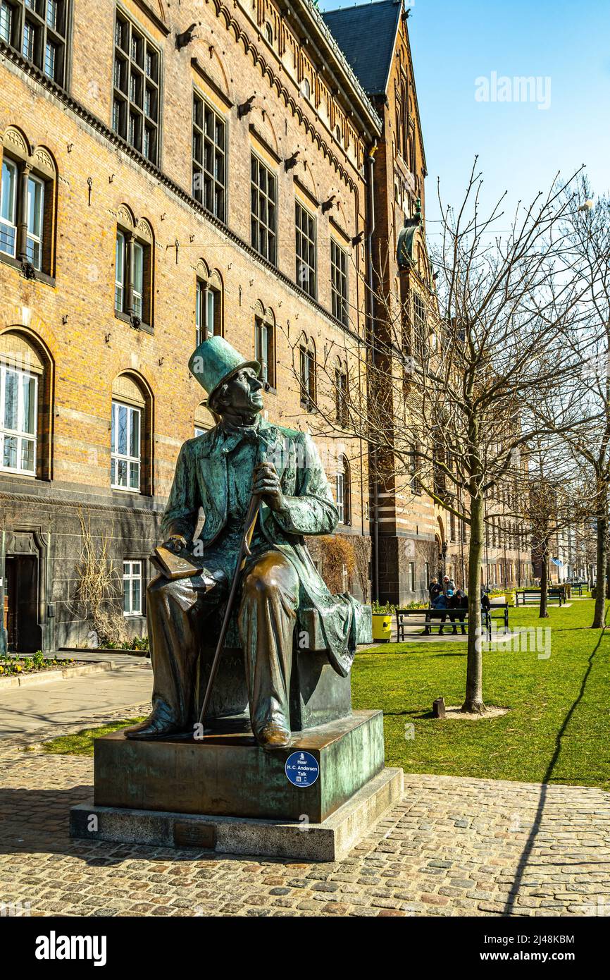 Bronze statue of the well-known fairy tale writer, Hans Christian Andersen, portrait with a top hat and a book, erected in 1965. Copenhagen, Stock Photo