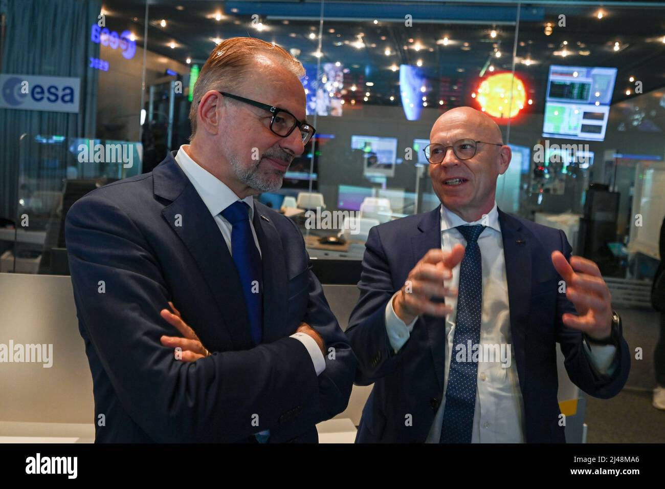 Darmstadt, Germany. 12th Apr, 2022. Josef Aschbacher (l), Director General of the European Space Agency ESA, and Rolf Densing, Director of Mission Operations of the European Space Agency ESA and Head of the Space Operations Center ESOC, talk to each other at the European Satellite Operations Center ESOC in Darmstadt. Credit: Arne Dedert/dpa/Alamy Live News Stock Photo