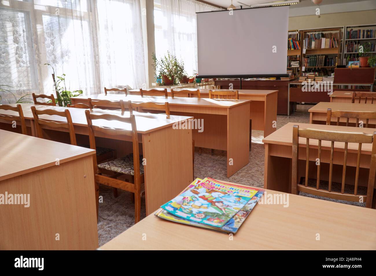 Chapaevsk, Samara region, Russia - January 24, 2020: An empty school classroom with a white screen Stock Photo