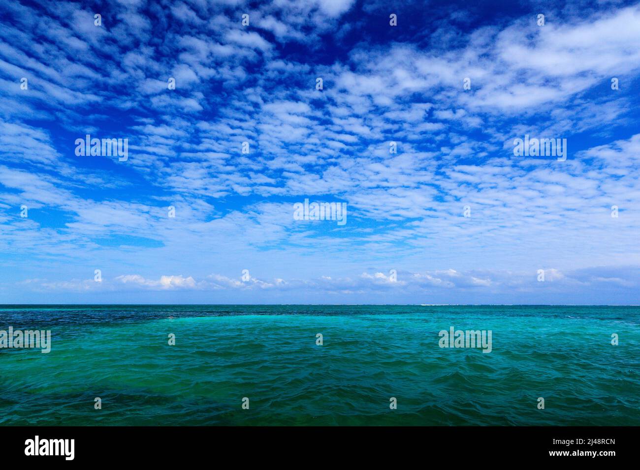 Sea in Caribbean with blue sky and white cloud. Water surface in ocean