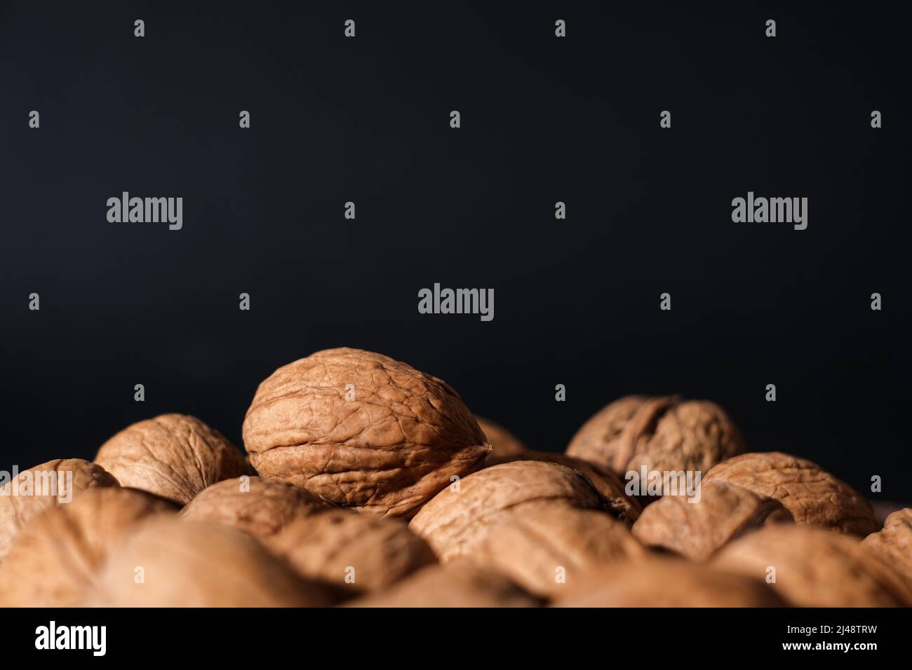 Walnuts on a dark background. Nutcracker close-up. Stock Photo
