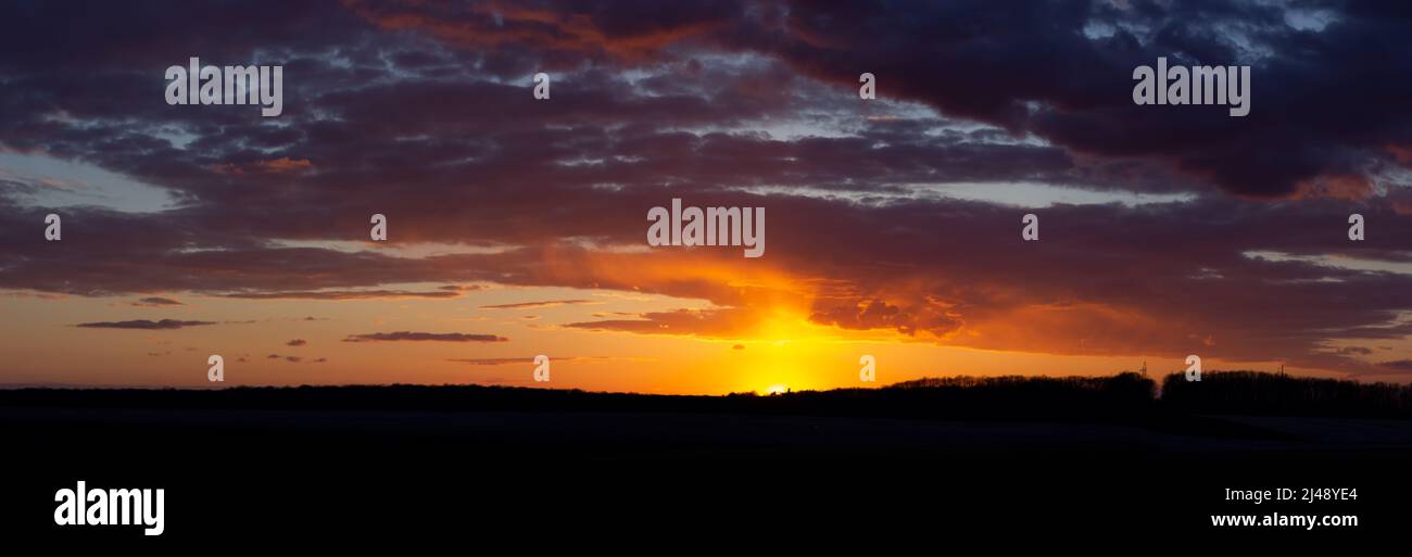 Breathtaking sunset with dramatic sky and clouds. Stock Photo