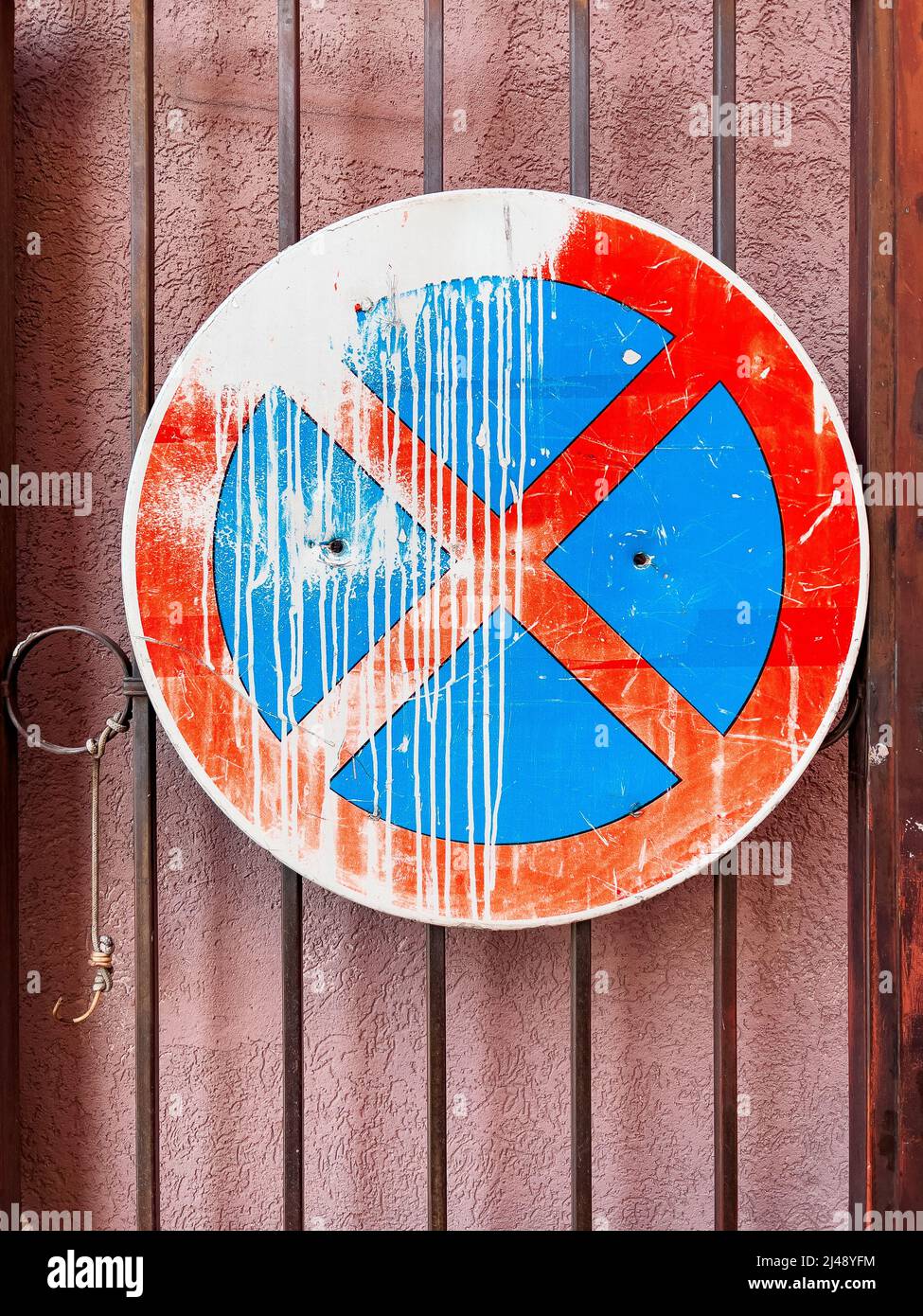 No stopping traffic sign with white paint spill mounted on the gate Stock Photo