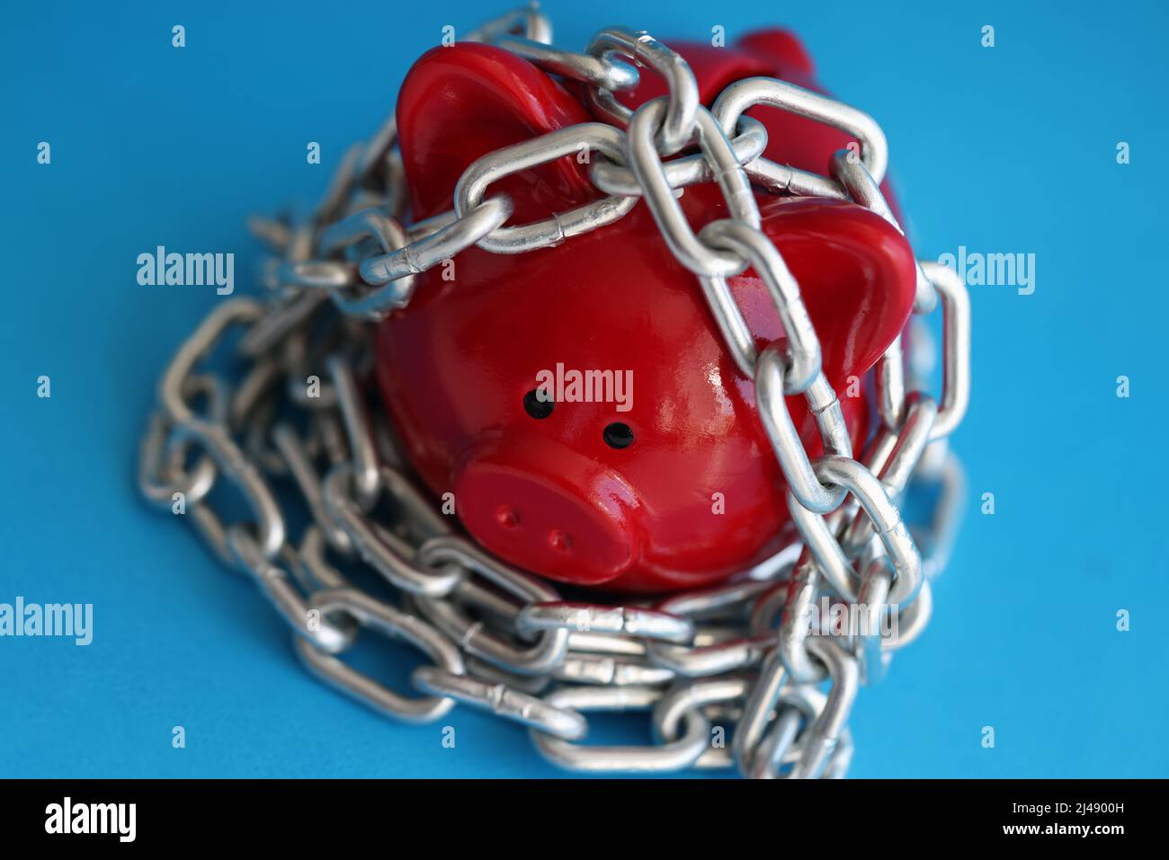 Piggy bank and chains, saving money for future and retirement fund Stock Photo