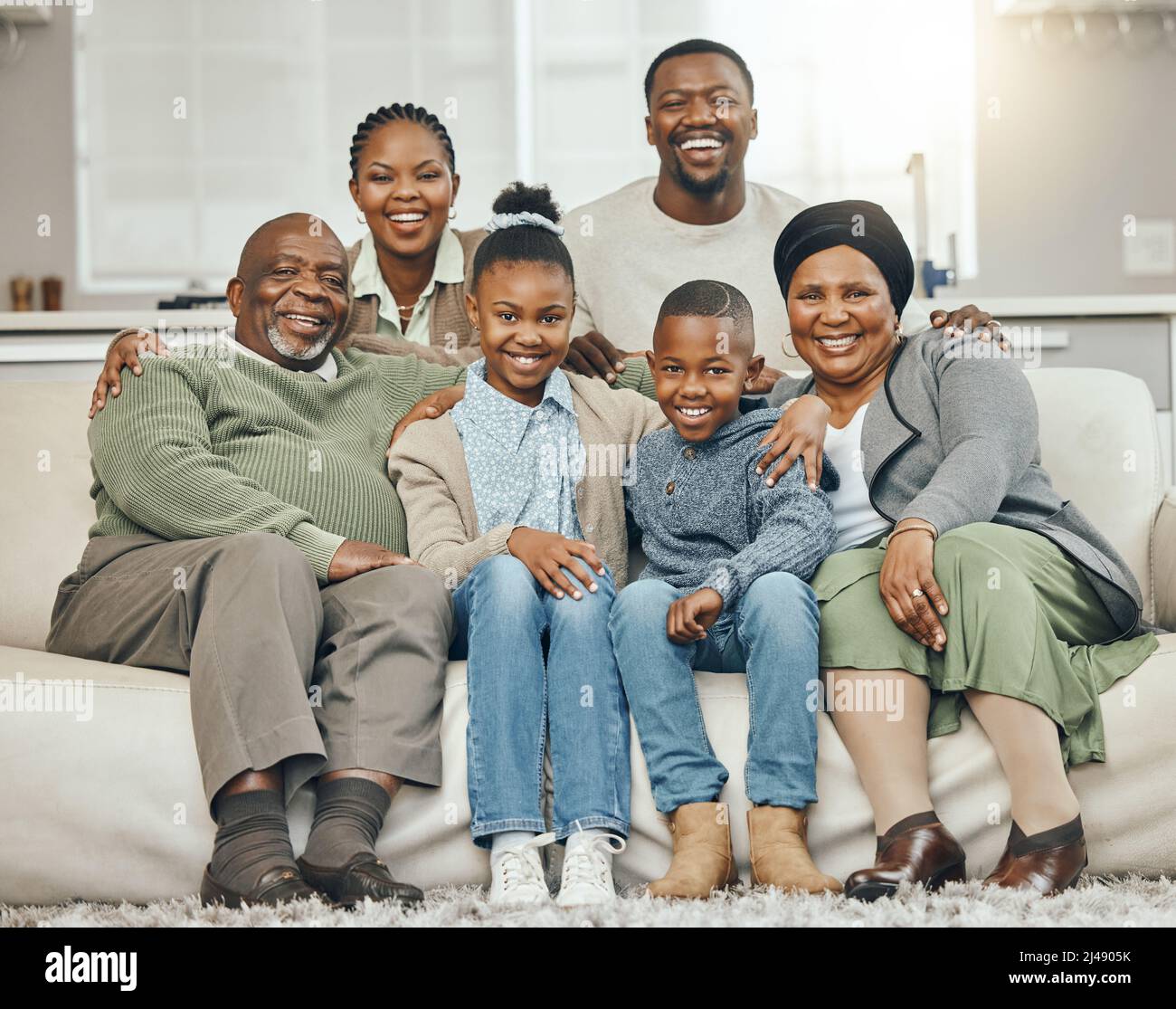 Family is forever. Shot of a family bonding on a sofa at home. Stock Photo