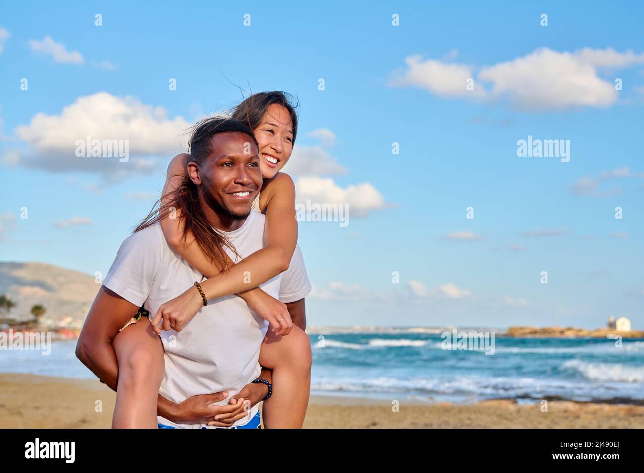 Happy young beautiful couple having fun on the beach, copy space Stock Photo