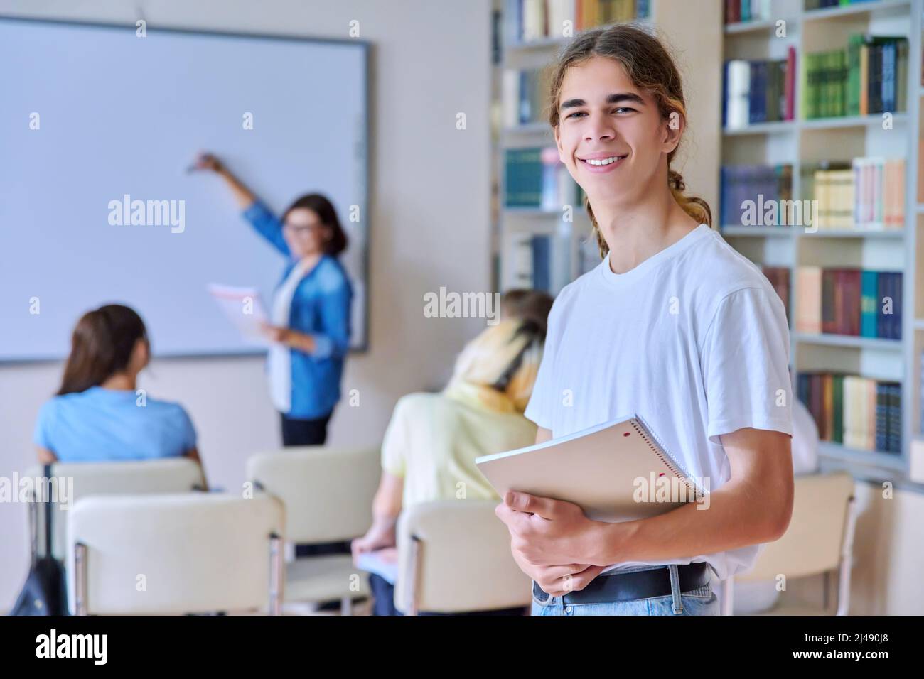 Teenage guy in the classroom looking at the camera Stock Photo