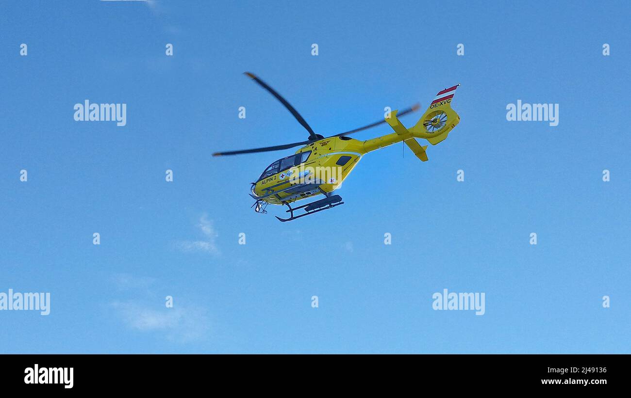 Stubai, Austria - December 22, 2015: Alpine emergency helicopter EC135 in action Stock Photo