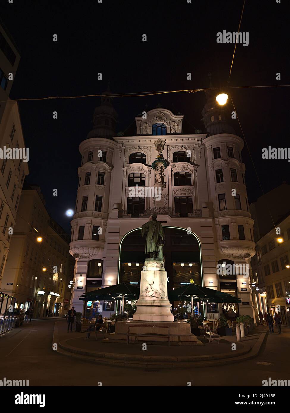 Front view of historic building Regensburger Hof in the old center of Vienna, Austria on town square Lugeck by night with illuminated facade. Stock Photo
