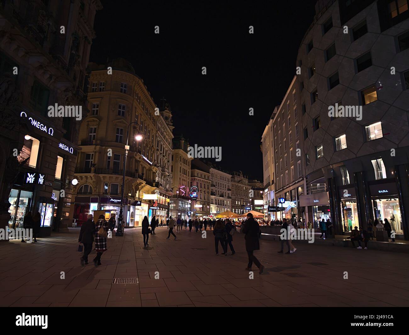View of shopping street Graben at night near Stephansplatz in the historic center of Vienna, Austria, with people walking by and illuminated shops. Stock Photo