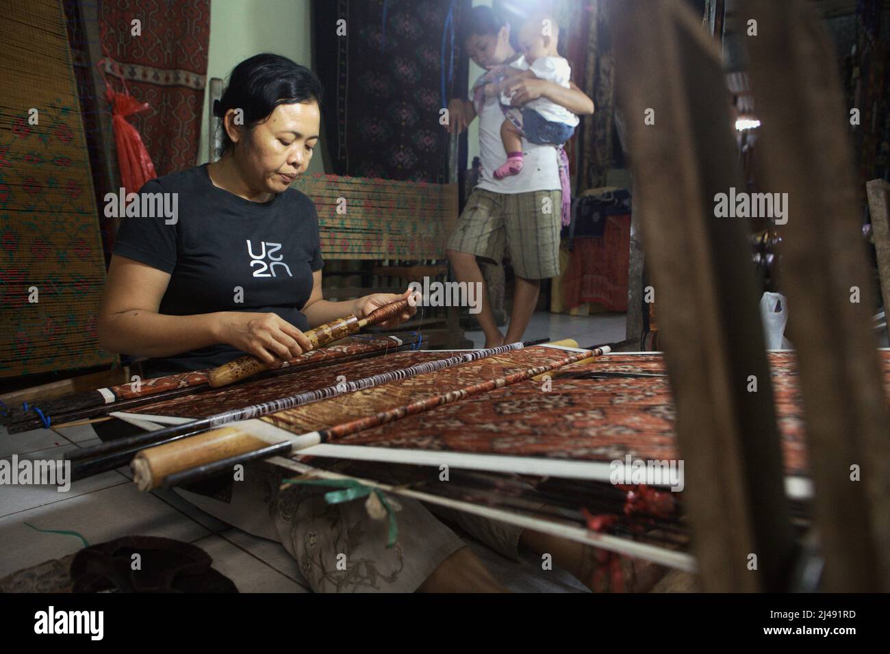 Ni Wayan Sudiati, a weaving artist, is working at her workshop in the traditional village of Tenganan Pegringsingan in Karangasem, Bali, Indonesia. Stock Photo