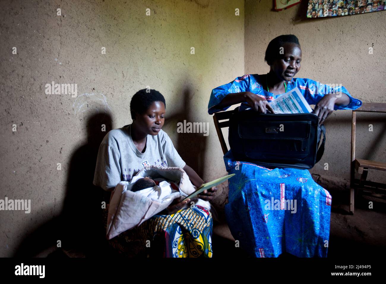 Paskazi Mukasangwa, a community health worker for maternal and new-born health, during a routine post-natal visit, Mbazi sector, Huye disrict.   Vestine Niyonsaba, 25, gave birth to her son four days before.  Photograph by Mike Goldwater Stock Photo