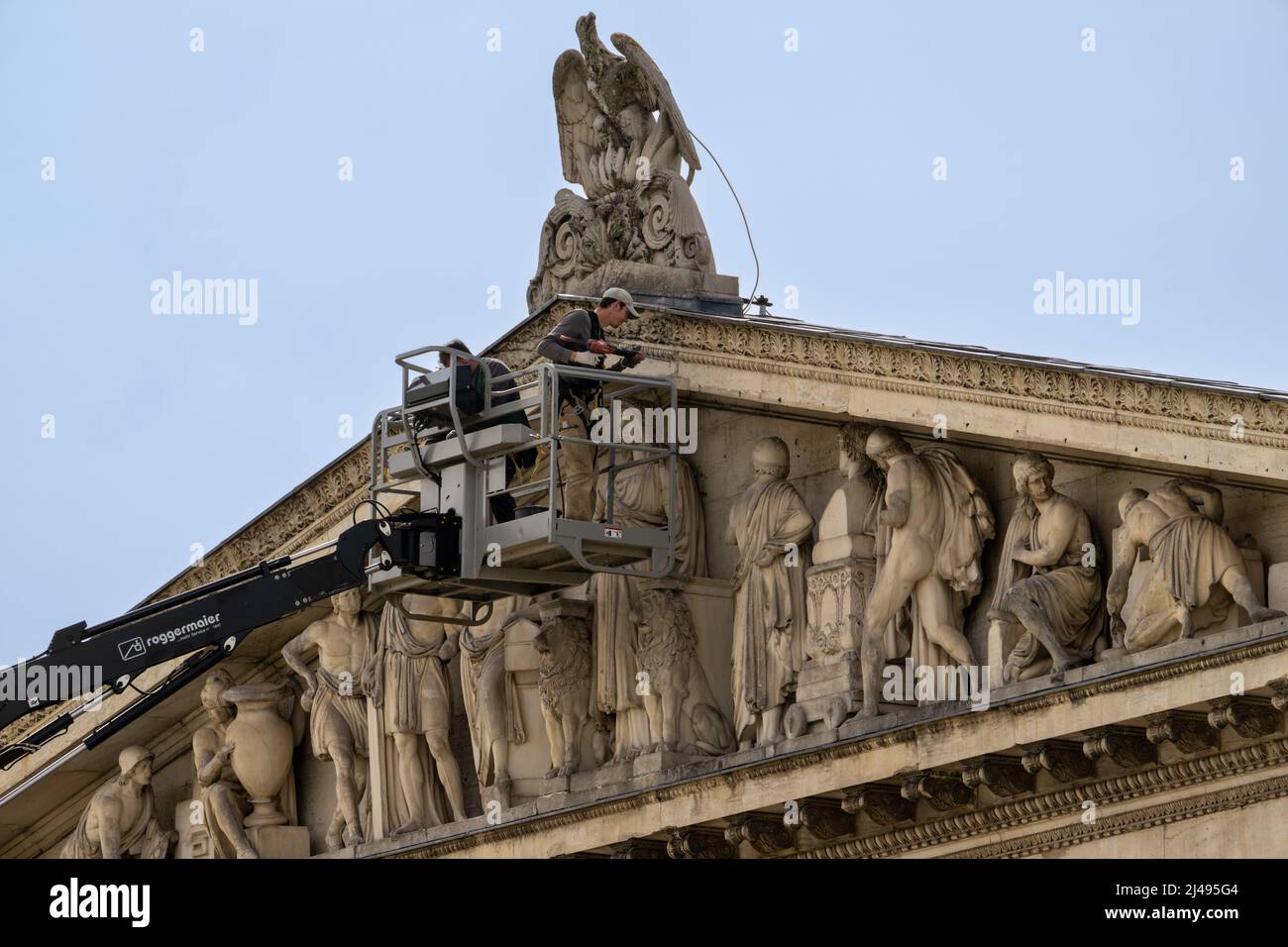 Munich, Germany. 13th Apr, 2022. Two men work on and examine the stone roof façade and frescoes above the entrance to the State Collection of Classical Antiquities on Königsplatz. Greek, Roman and Etruscan masterpieces are on display in the Antiquities Collections. Works of art and utilitarian objects of the Greeks, Etruscans and Romans made of a wide variety of materials such as ceramics, metal and stone are housed in the building. Credit: Peter Kneffel/dpa/Alamy Live News Stock Photo